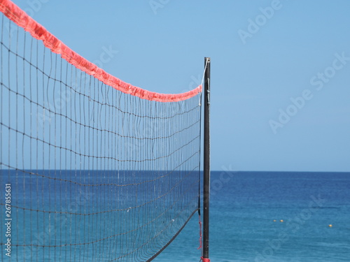 Closeup of a volleyball net on the beach.
