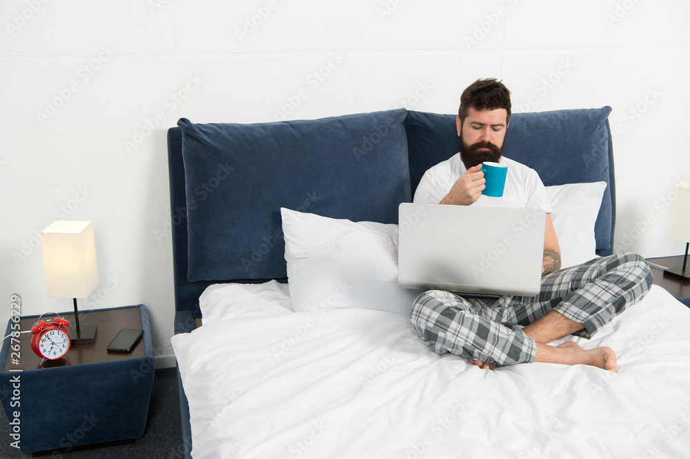 Taking rest hard working day. energy and tiredness. businessman with computer. bearded man hipster work on laptop. sleepy man in bedroom. mature male drink coffee. asleep and awake