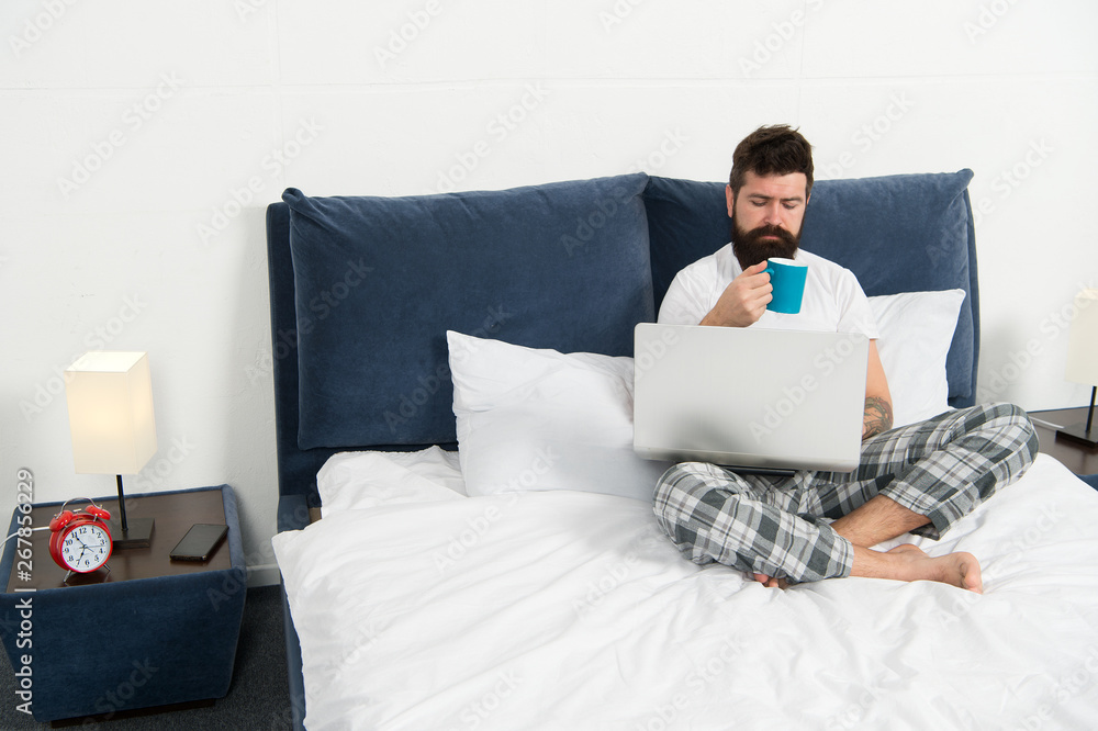 Taking rest hard working day. energy and tiredness. businessman with computer. bearded man hipster work on laptop. sleepy man in bedroom. mature male drink coffee. asleep and awake Taking rest hard working day. energy and tiredness. businessman with computer. bearded man hipster work on laptop. sleepy man in bedroom. mature male drink coffee. asleep and awake