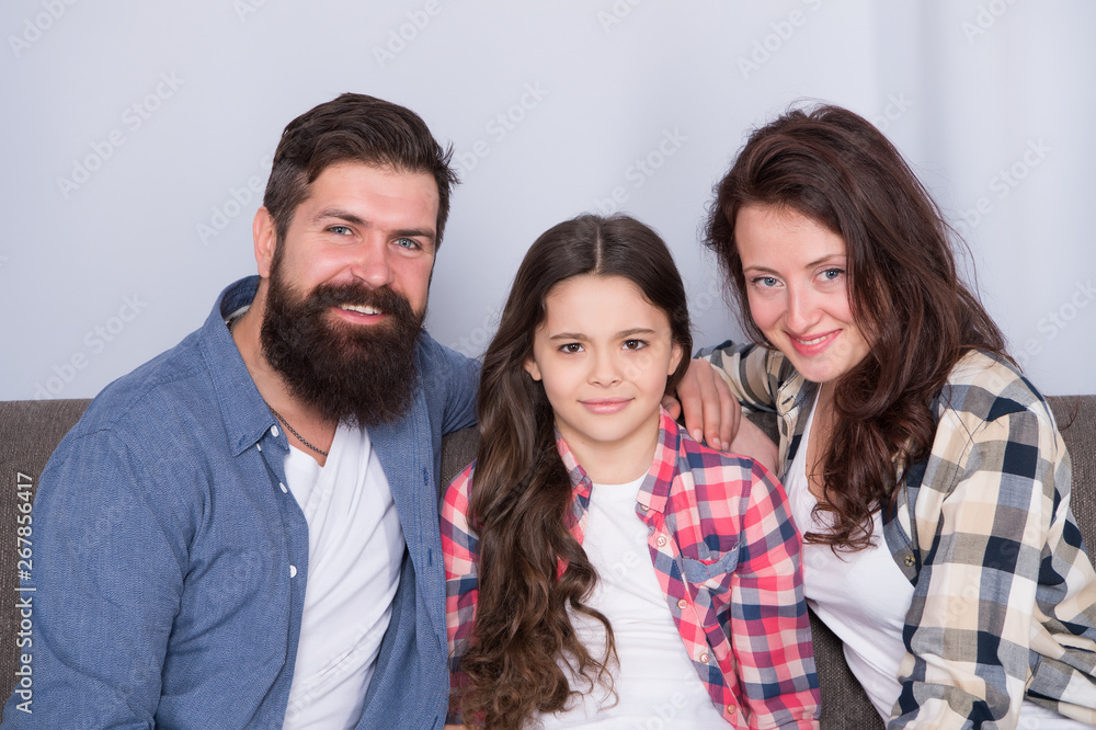 Family spend weekend together. Friendly family sit couch posing for photo family album. Mom dad and daughter smiling relaxing on couch. Family bonds concept. Typical family with single child