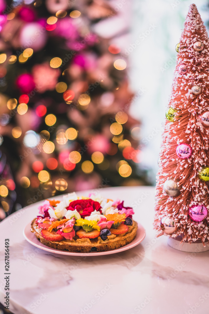 Colorful christmas decor with waffle with fruit and flowers