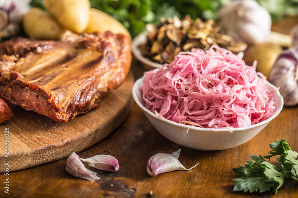 Sour cabbage dried mushrooms smoked pork ribs sausages garlic potatoes and celery herbs Sour cabbage dried mushrooms smoked pork ribs sausages garlic potatoes and celery herbs