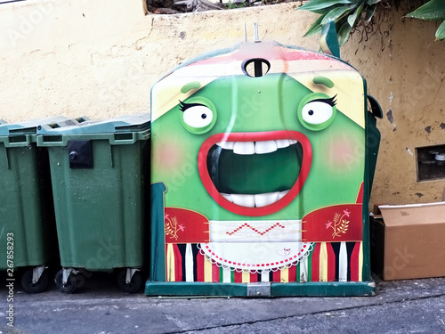 A large dumpster for glass with a special outfit, a big open woman's mouth photo