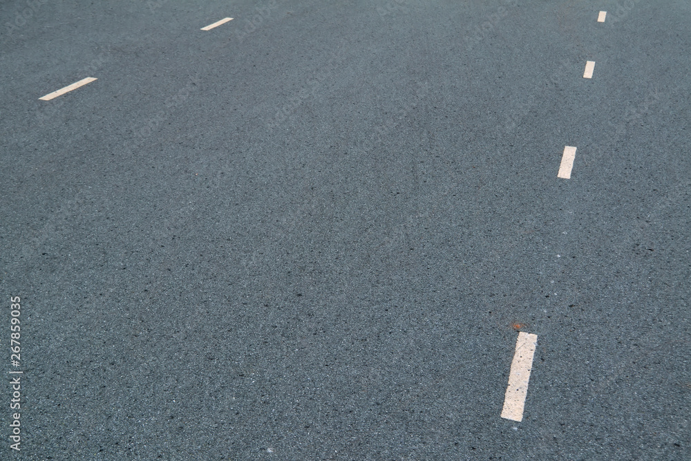 White dotted lines marking on asphalt natural background. Roadway line.