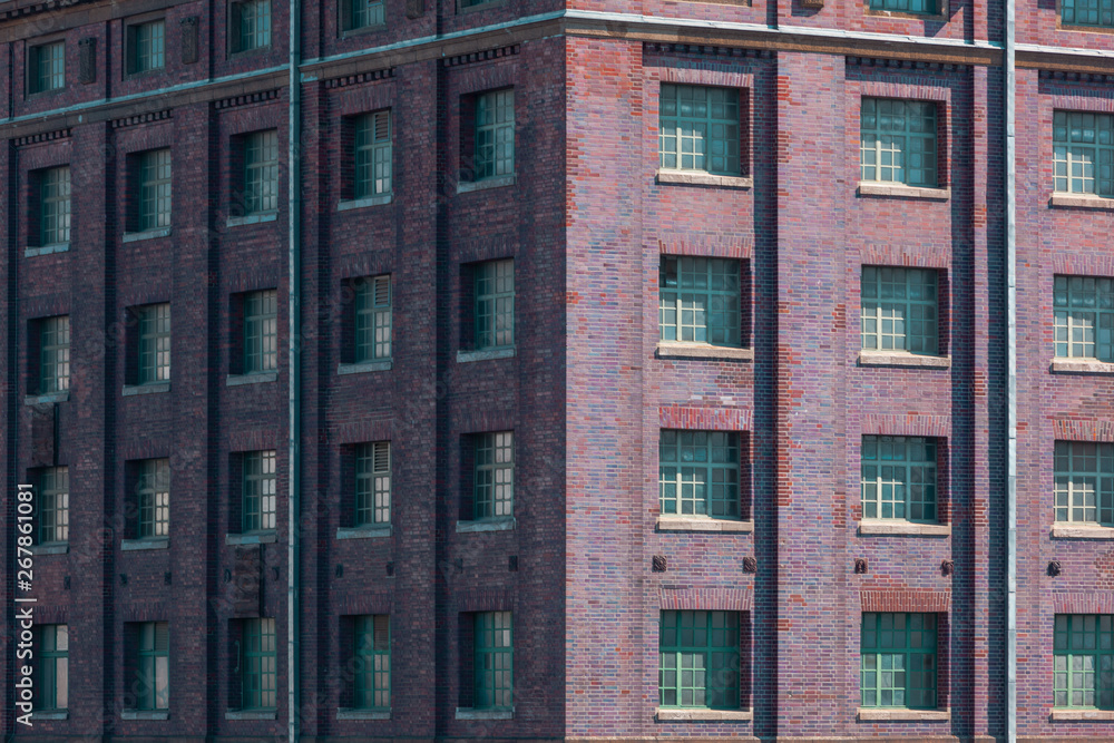 Corner of an old industrial red Brickstone Building with many Windows Corner of an old industrial red Brickstone Building with many Windows