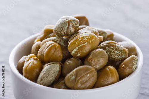 Tableau sur toile pickled capers on a dark stone background