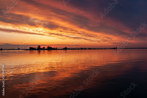 dark orange sunset spring evening on the river or reservoir
