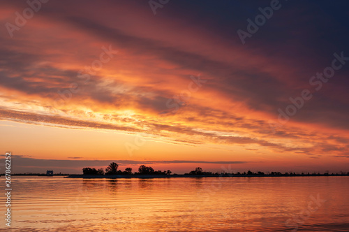 dark orange sunset spring evening on the river or reservoir