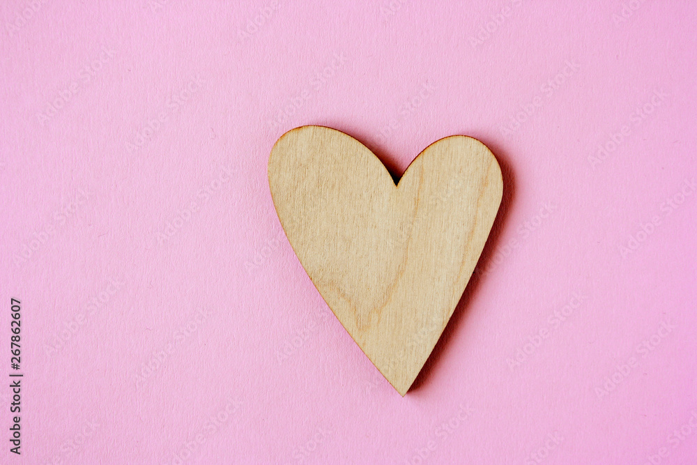 Minimal concept of wooden heart against pastel pink background. Minimal concept of wooden heart against pastel pink background.