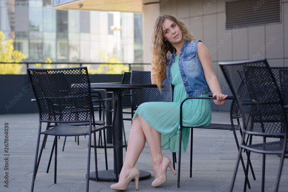 beautiful girl in a cafe on the street.emotions beautiful girl in a cafe on the street.emotions