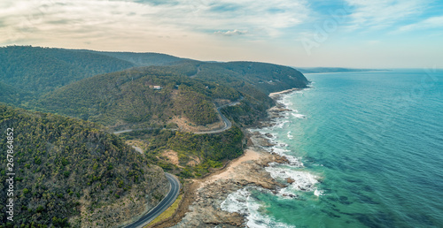 The famous Great Ocean Road winding along the coastline - aerial panorama