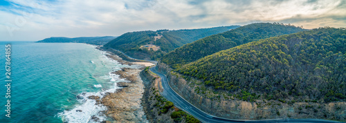 Great Ocean Road passing through scenic landscape in Victoria, Australia - aerial panoramic landscape photo