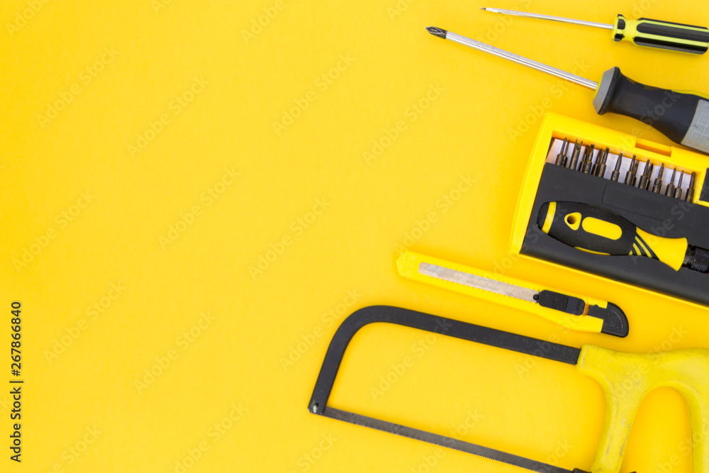DIY tool set. Tools lie on a yellow background. There is a place for text.