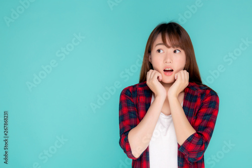 Beautiful portrait young asian woman surprise wearing travel summer fashion with tourist in vacation isolated on blue background, girl shocked expression and emotion, tourist, holiday amazing concept.