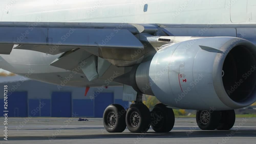 Jet turbine engine of aircraft on runway in airport. Working jet engine of passenger airliner and heat shimmer behind it. jet engine turbine turning. working airplane turbo engine. aviation security Jet turbine engine of aircraft on runway in airport. Working jet engine of passenger airliner and heat shimmer behind it. jet engine turbine turning. working airplane turbo engine. aviation security