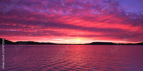 Magenta coloured altostratus cloudy Sunrise Seascape Panorama.