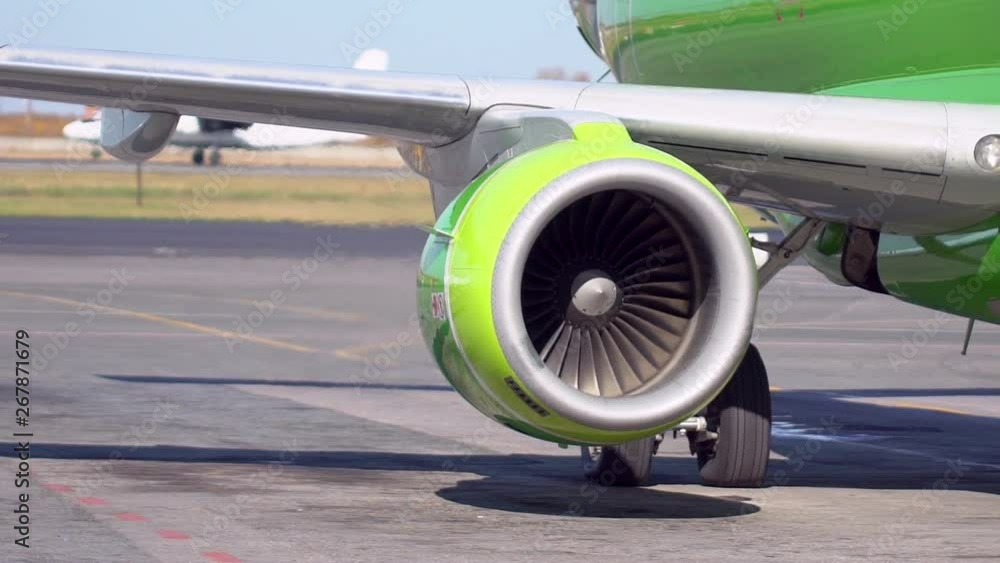 Turning Jet Engine Jet turbine engine of aircraft on runway in airport. Working jet engine ...