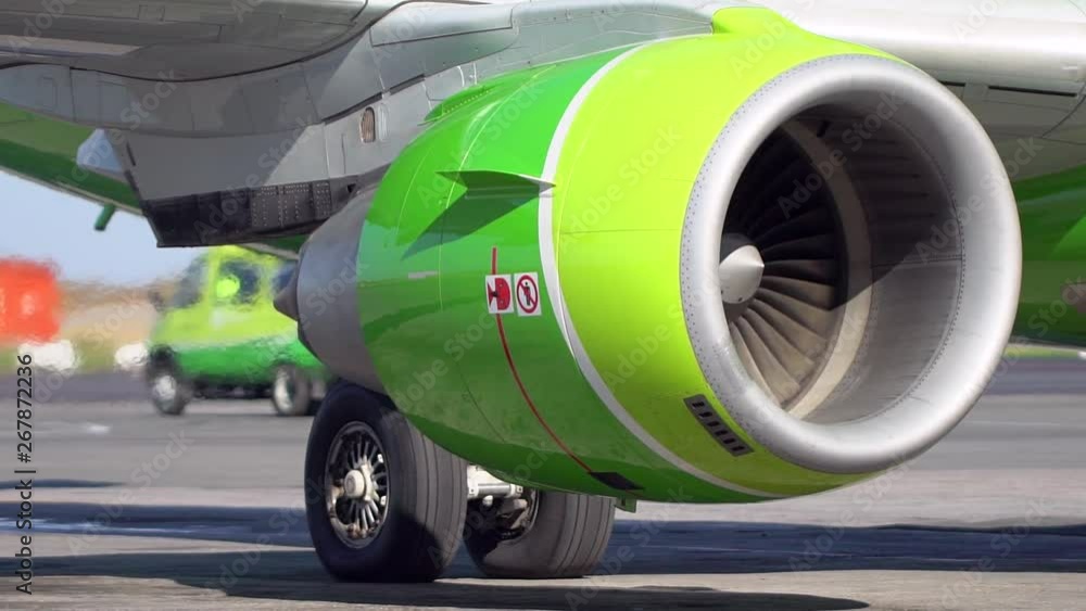 Turning Jet Engine Jet turbine engine of aircraft on runway in airport. Working jet engine ...