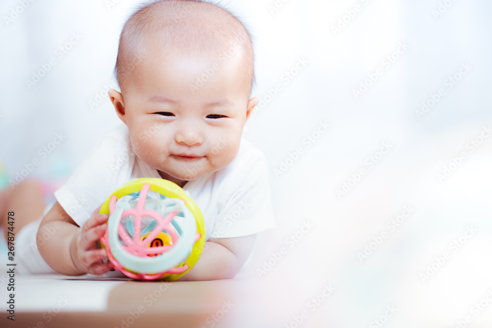 Asian baby happy in the room.Asian baby girl lying down on bed . Asian baby happy in the room.Asian baby girl lying down on bed .