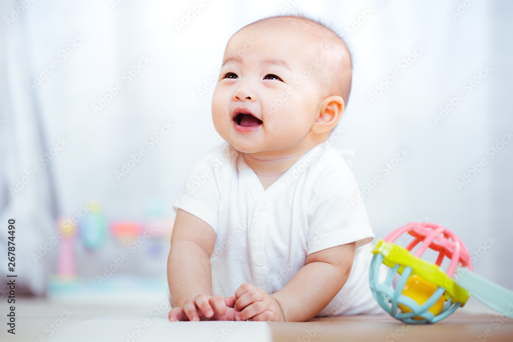 Asian baby happy in the room.Asian baby girl lying down on bed . Asian baby happy in the room.Asian baby girl lying down on bed .