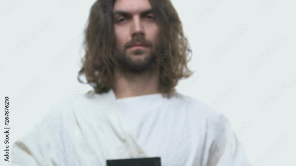 Preacher holding holy Bible in hands, reading Word of God to parishioners Preacher holding holy Bible in hands, reading Word of God to parishioners