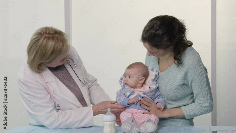 Pediatrician consulting with mother about her newborn Pediatrician consulting with mother about her newborn