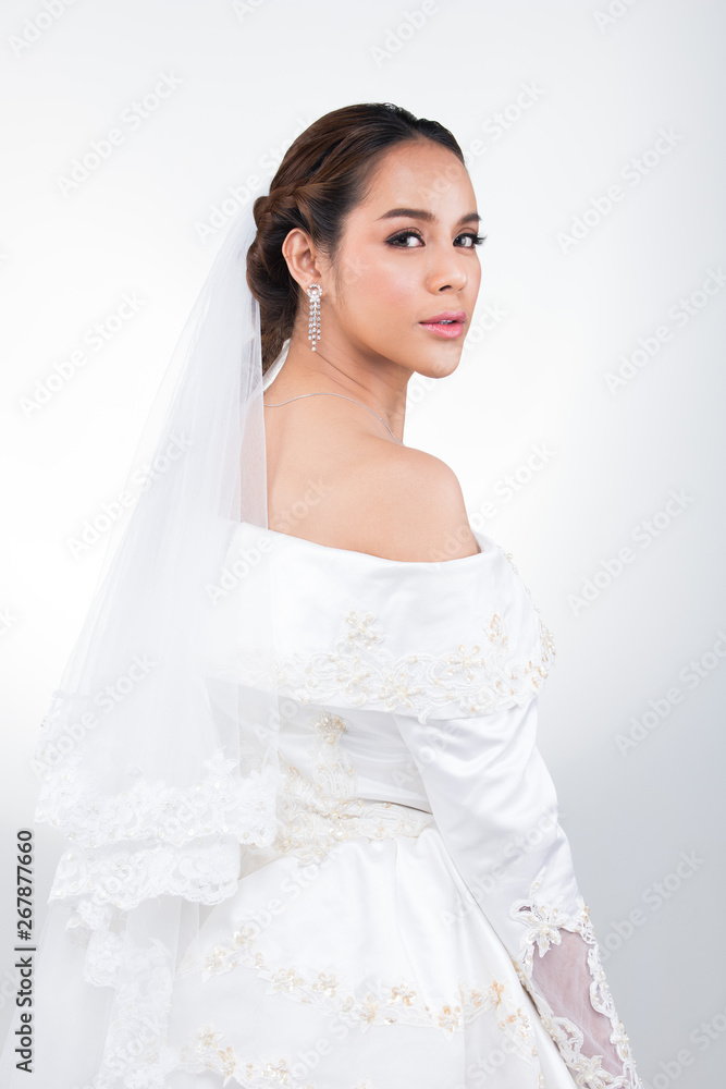Lovely Asian Beautiful Woman bride in white wedding gown dress with lace veil, black hair, studio lighting white grey gradient background isolated copy space, sweet romantic soft alone bridal concept Lovely Asian Beautiful Woman bride in white wedding gown dress with lace veil, black hair, studio lighting white grey gradient background isolated copy space, sweet romantic soft alone bridal concept