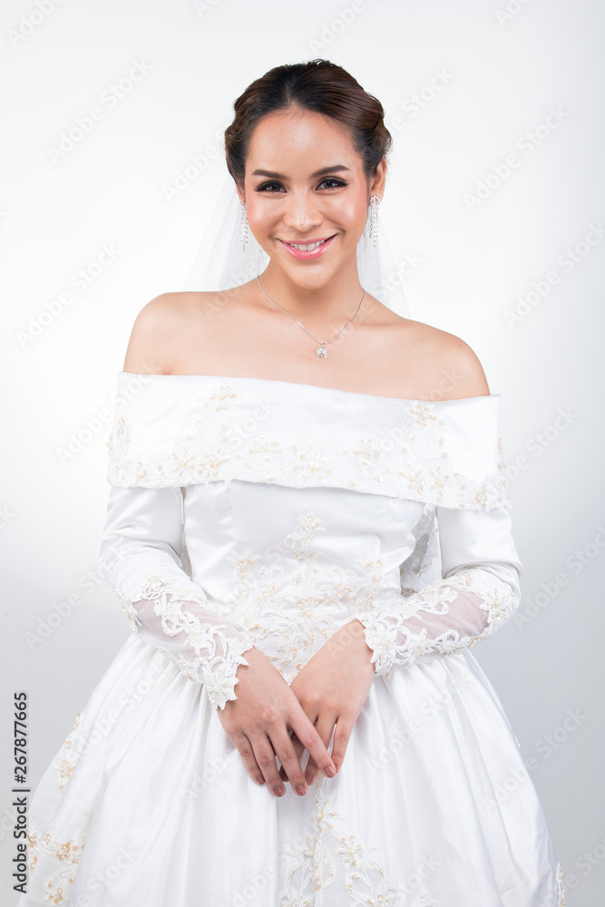 Lovely Asian Beautiful Woman bride in white wedding gown dress with lace veil, black hair, studio lighting white grey gradient background isolated copy space, sweet romantic soft alone bridal concept Lovely Asian Beautiful Woman bride in white wedding gown dress with lace veil, black hair, studio lighting white grey gradient background isolated copy space, sweet romantic soft alone bridal concept