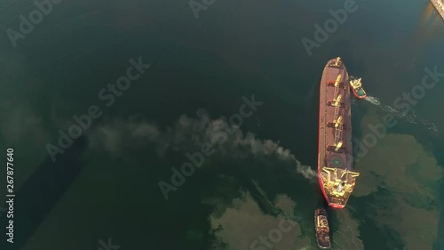 Aerial view on Cargo Ship Polluting Air With Smoke