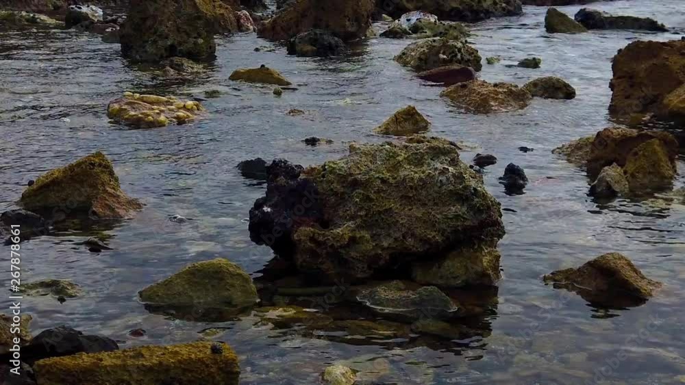 Calm waters waiting to be turn into wave powered force to hit the rocks going to shore Calm waters waiting to be turn into wave powered force to hit the rocks going to shore