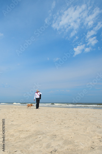 Business man with dog at the beach