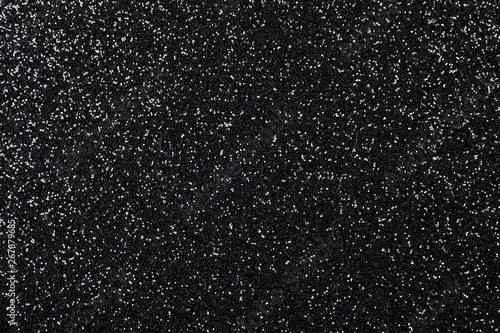 Black foam surface with glitter.