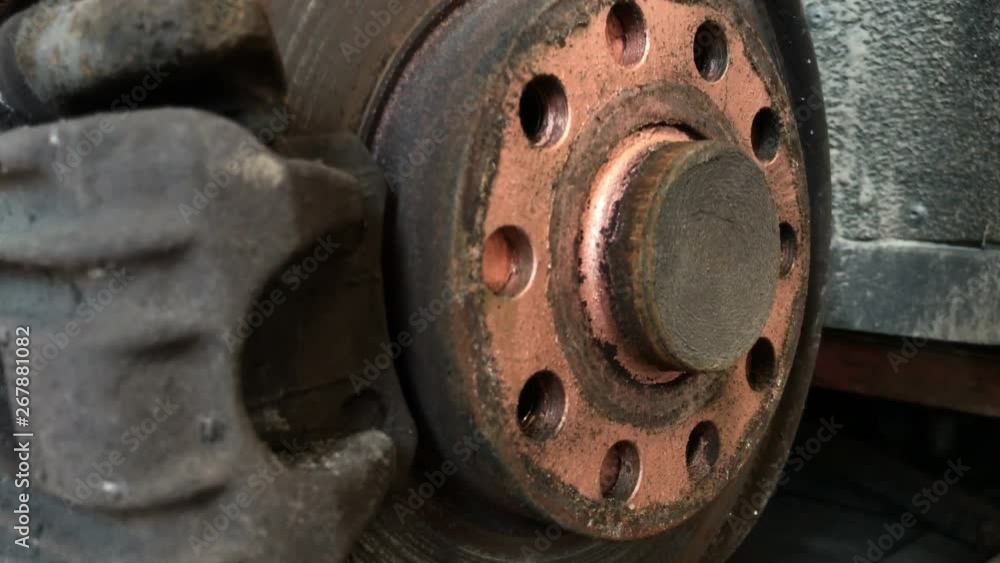 Closeup shot of rusty used disc brake with wheel mounting holes covered by cooper grease. Danger of braking problems. Closeup shot of rusty used disc brake with wheel mounting holes covered by cooper grease. Danger of braking problems.