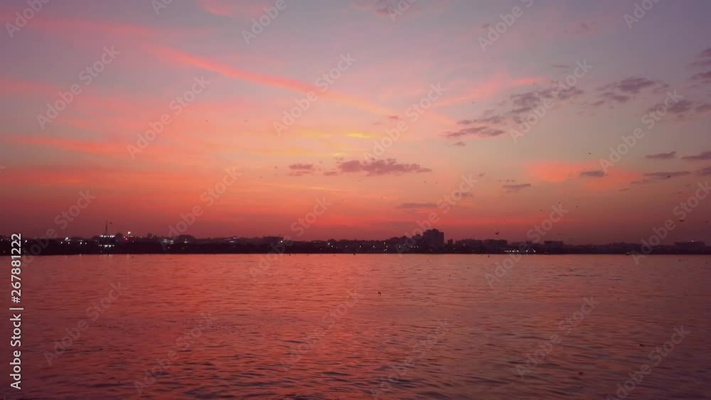 Birds Flying Through Lake During Sunset. Birds Flying Through Lake During Sunset.
