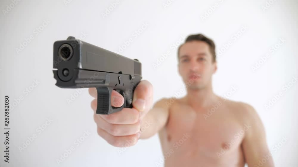 Naked man aims his gun on white background Naked man aims his gun on white background