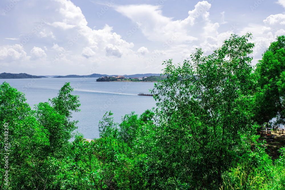 Beautiful nature scene beside the river in Batam Island, Indonesia, Horizontal landscape sea view with bright sky clouds, Green nature background with white clouds Beautiful nature scene beside the river in Batam Island, Indonesia, Horizontal landscape sea view with bright sky clouds, Green nature background with white clouds