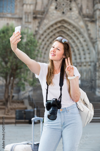 Enthusiastic female tourist making selfie