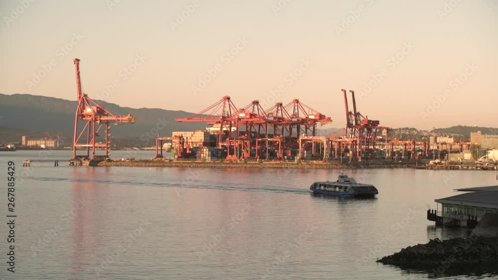 Vancouver Harbor Cranes and Ferry 4K UHD. Commuters travel across Burrard Inlet to downtown Vancouver in the morning. 4K. UHD. Vancouver Harbor Cranes and Ferry 4K UHD. Commuters travel across Burrard Inlet to downtown Vancouver in the morning. 4K. UHD.