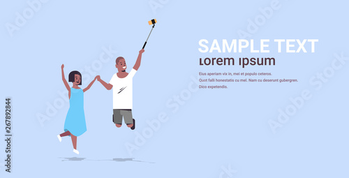 couple using selfie stick african american man woman taking photo on smartphone camera boyfriend girlfriend jumping having fun male female cartoon characters full length horizontal copy space