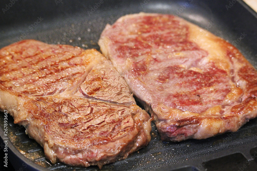 Two steaks cooked on the pan Two steaks cooked on the pan