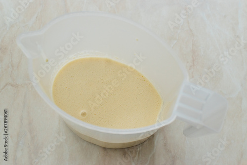 Raw Pancake Dough in Plastic Carafe Ready to Pour on Pan.