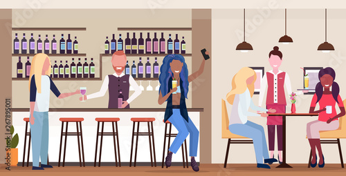 african girl taking selfie photo on smartphone camera mix race people relaxing in bar drinking cocktails barman and waitress serving clients modern cafe interior flat horizontal full length
