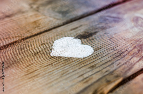 white heart on wooden background. Love and feelings