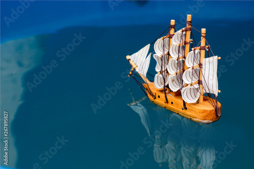 Canvas Print small toy boat in the water with big waves,