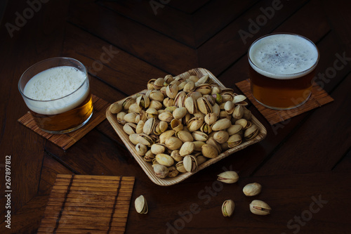 summer party in a pub. beer and recyclable bowl of pistachios and