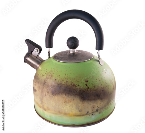 Kettle damaged by fire from a gas stove. Isolated on a white background