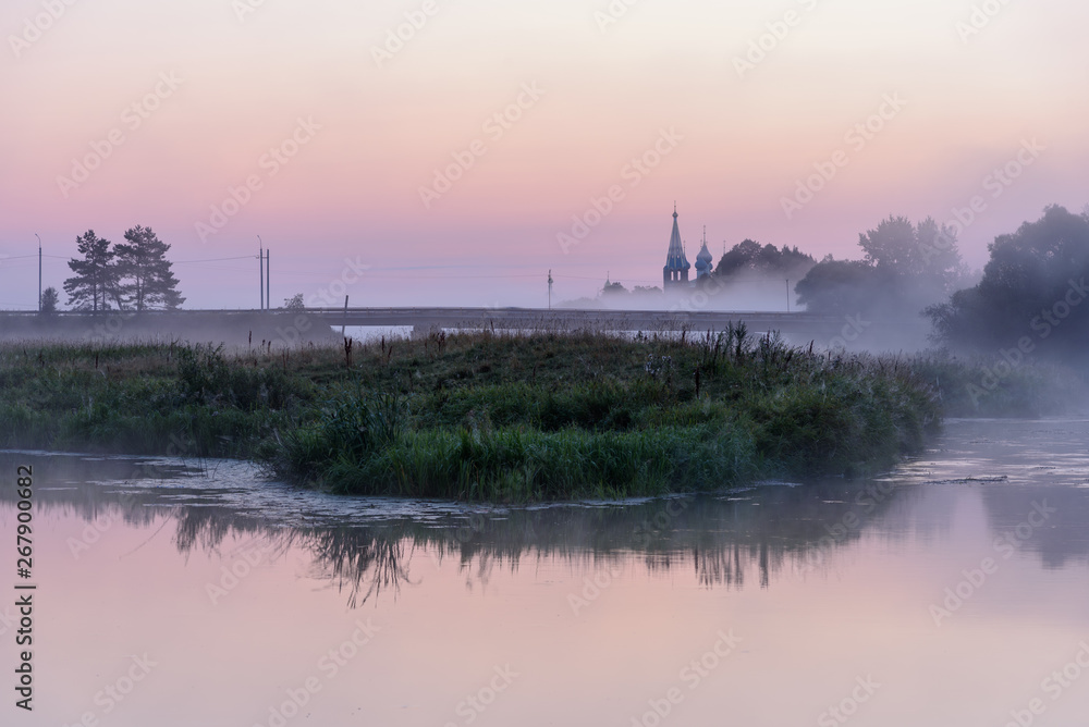 Morning outside the city, rural landscape. Fog on the river in the village of Dunilovo, Russia