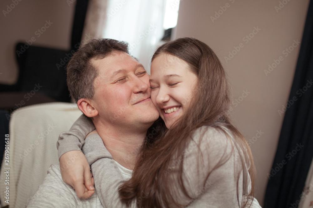 portrait of a happy father and beautiful daughter they laugh, indoor portrait of a happy father and beautiful daughter they laugh, indoor