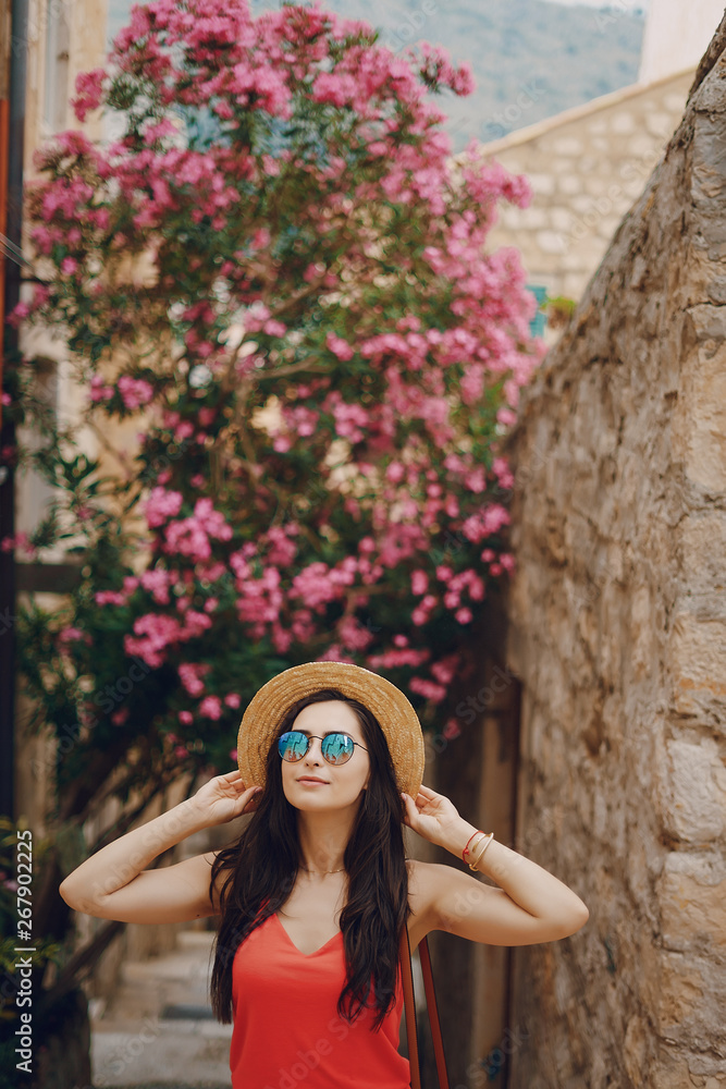 beautiful girl in a bright dress and a sunglasses sit in a summer sunny city beautiful girl in a bright dress and a sunglasses sit in a summer sunny city