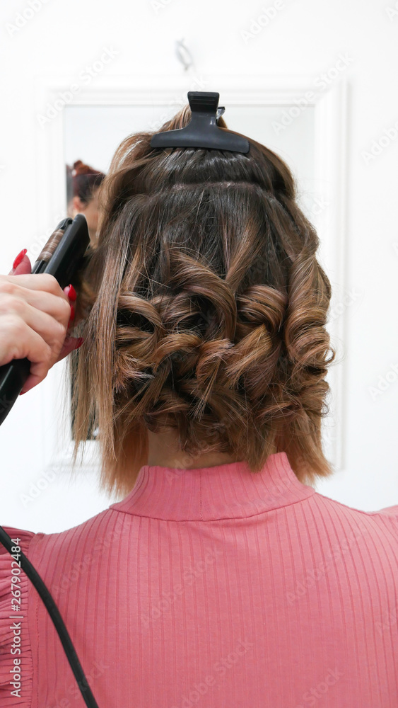 Fototapeta premium Female Hairstyles on curling in a beauty salon 